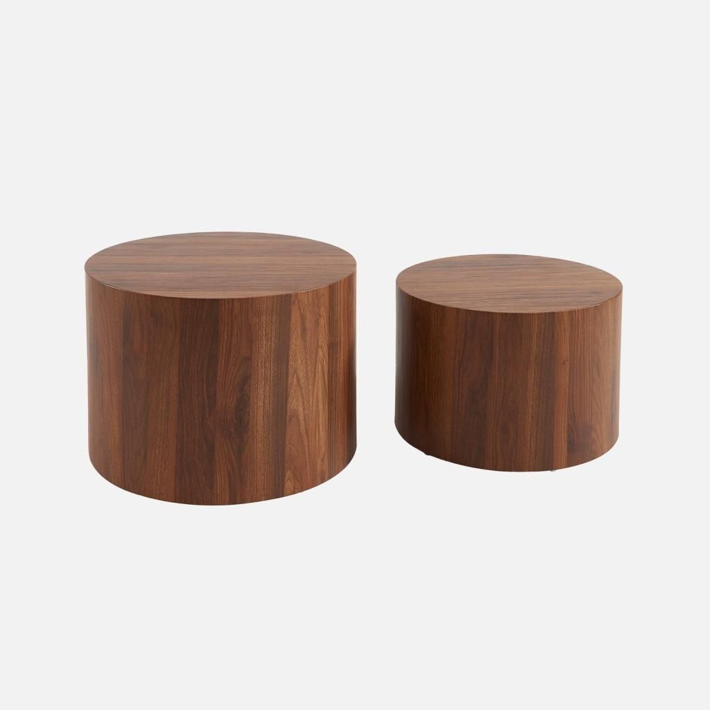 Two round wooden side tables of different sizes against a white background.