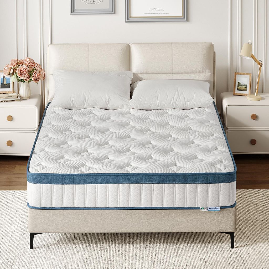 A mattress is displayed on a bed frame, with pillows and a headboard.