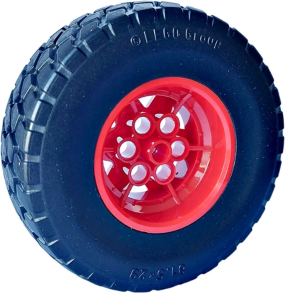 A close-up studio shot of a single LEGO tire with a red rim.
