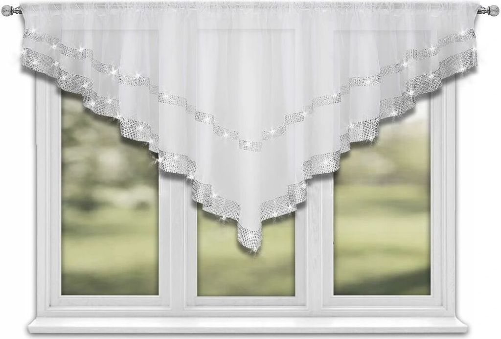A white triangular curtain with silver trim hangs in a window.