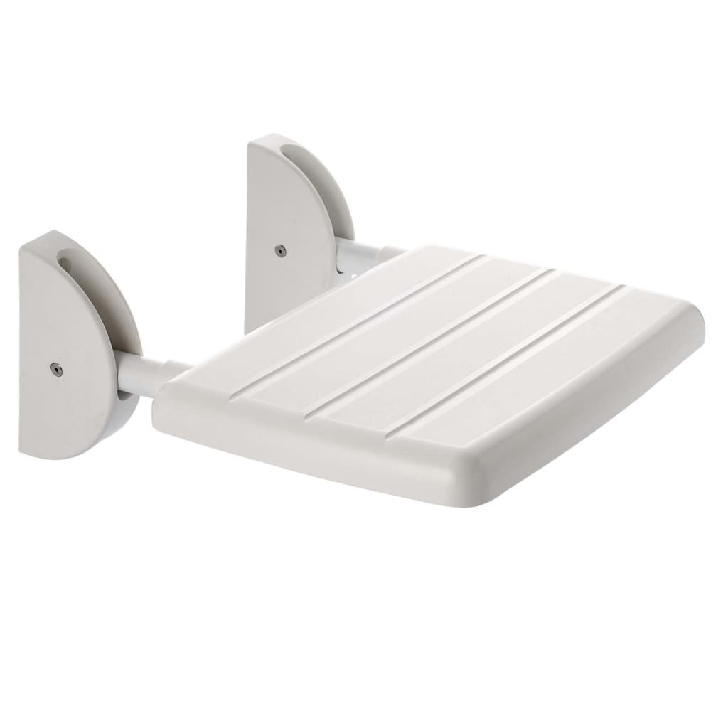 A white folding shower seat mounted on a white wall.
