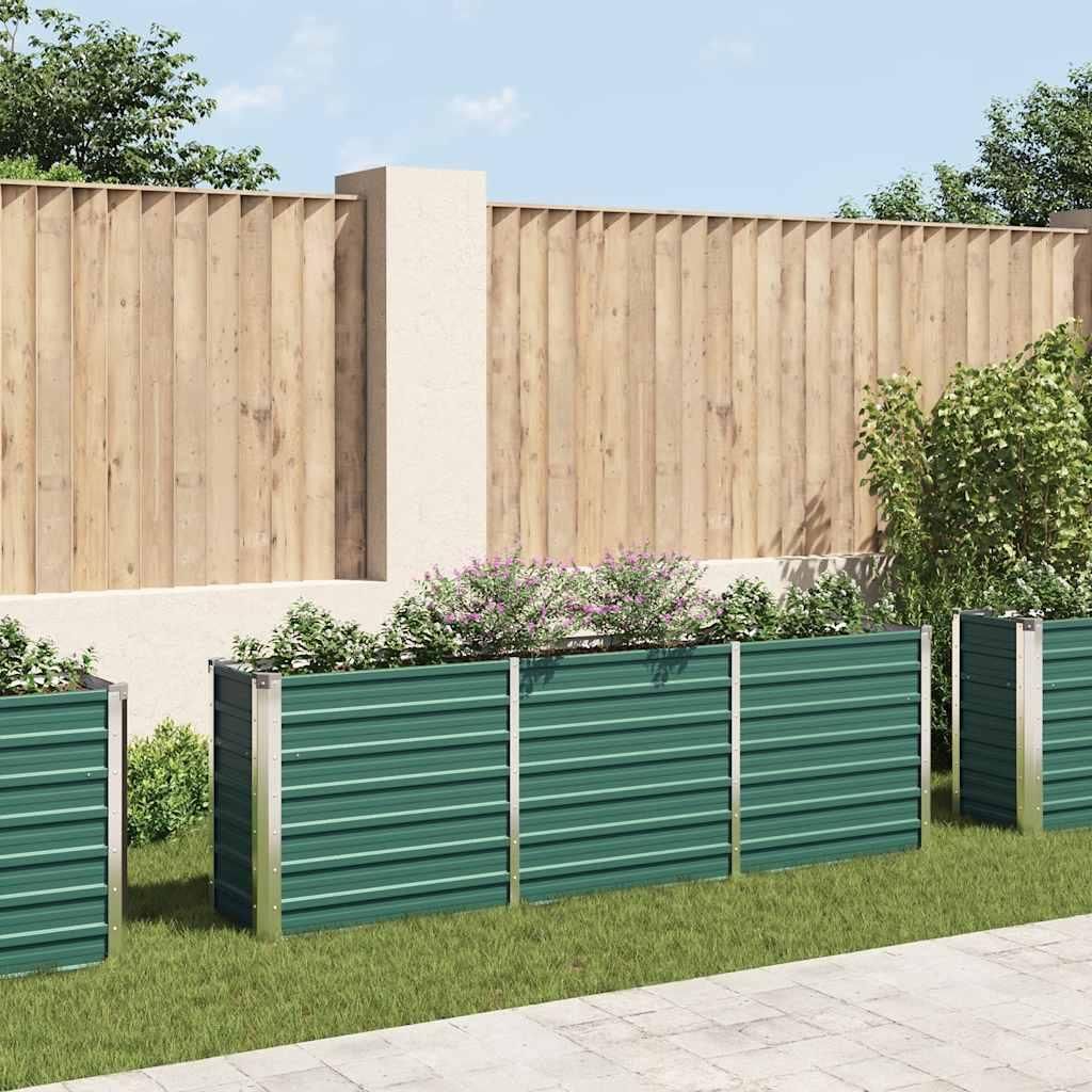 A backyard scene with raised garden beds in front of a wooden fence.
