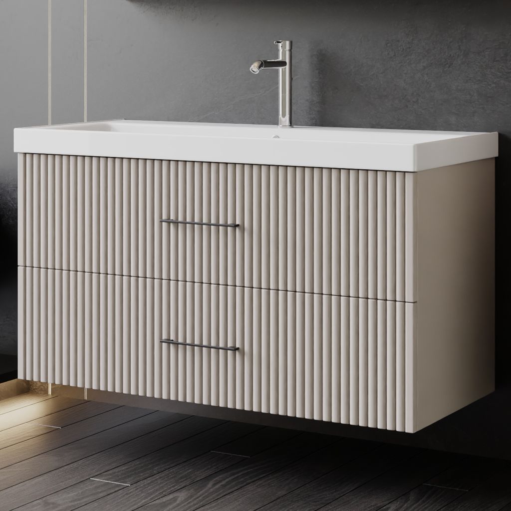 A modern bathroom vanity with a sink and faucet against a dark gray wall.