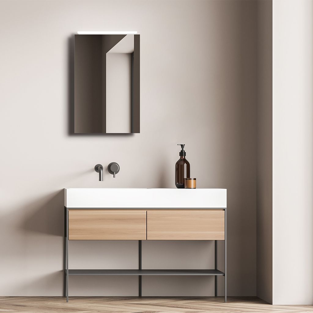 A modern bathroom vanity with a mirror and sink.