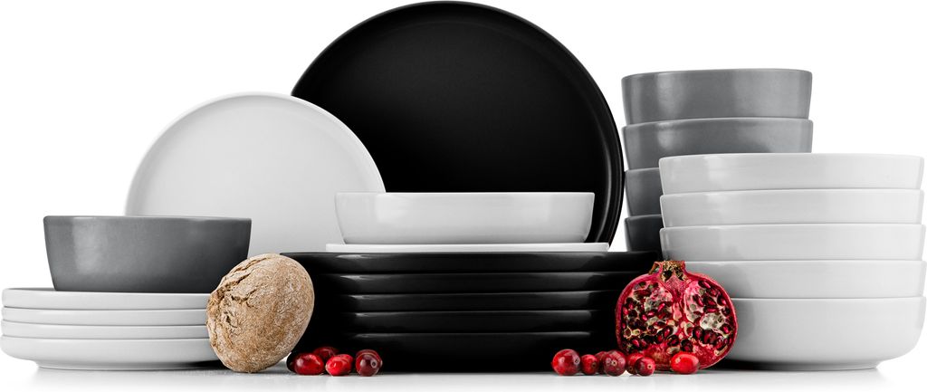 A collection of ceramic dishes in various sizes and colors, including plates and bowls, arranged together.
