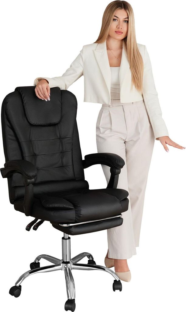 A woman in business attire posing next to a black office chair.