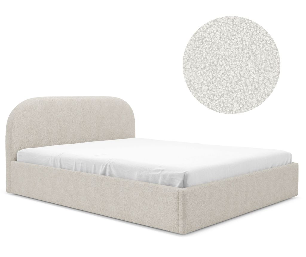 A bed with a curved headboard and a mattress.