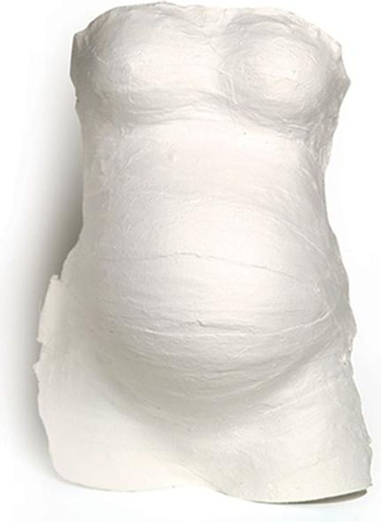 A white plaster cast of a pregnant belly, likely a DIY kit for creating a keepsake.