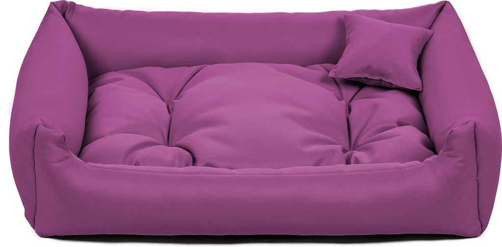 A purple dog bed with a small pillow on a white background.