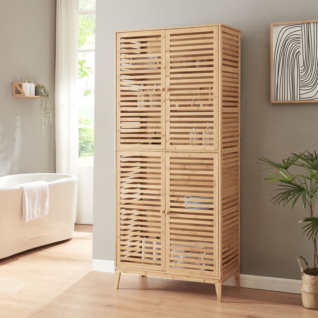 A bathroom with a bathtub and a tall wooden cabinet.