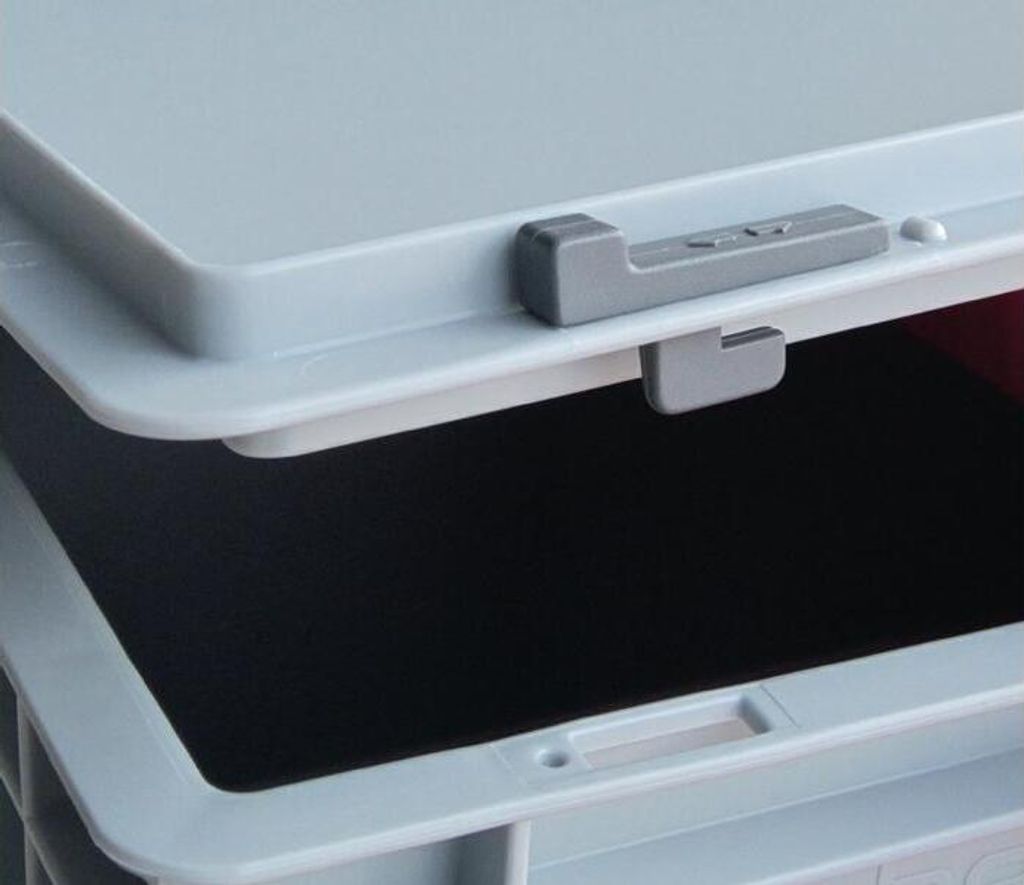 A close-up view of a gray plastic latch mechanism on a light gray storage container lid.