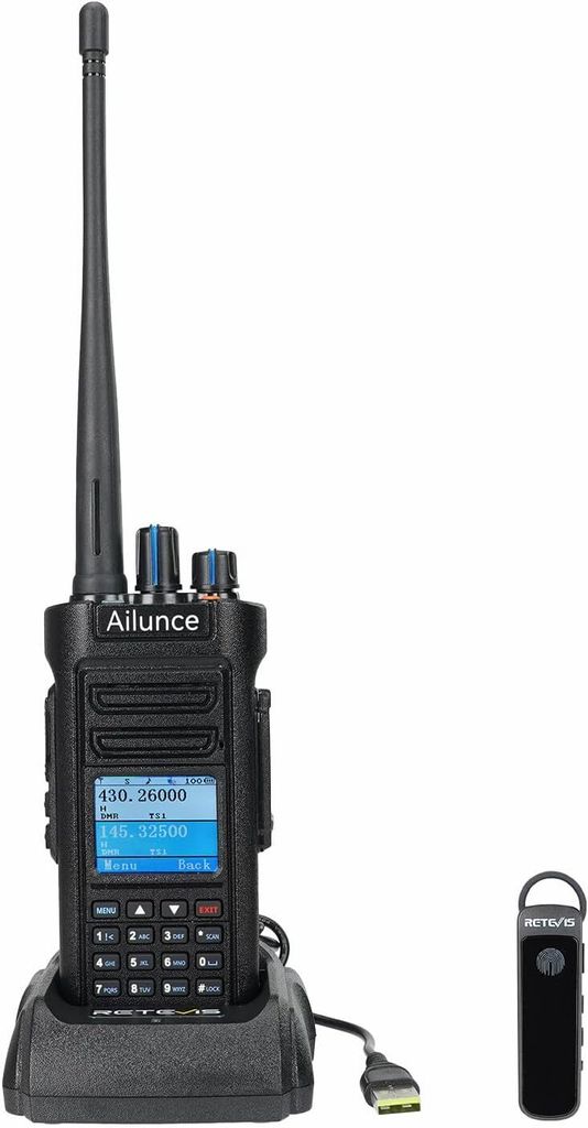 A black handheld radio and its charging dock are shown on a white background, with a small black accessory to the right.