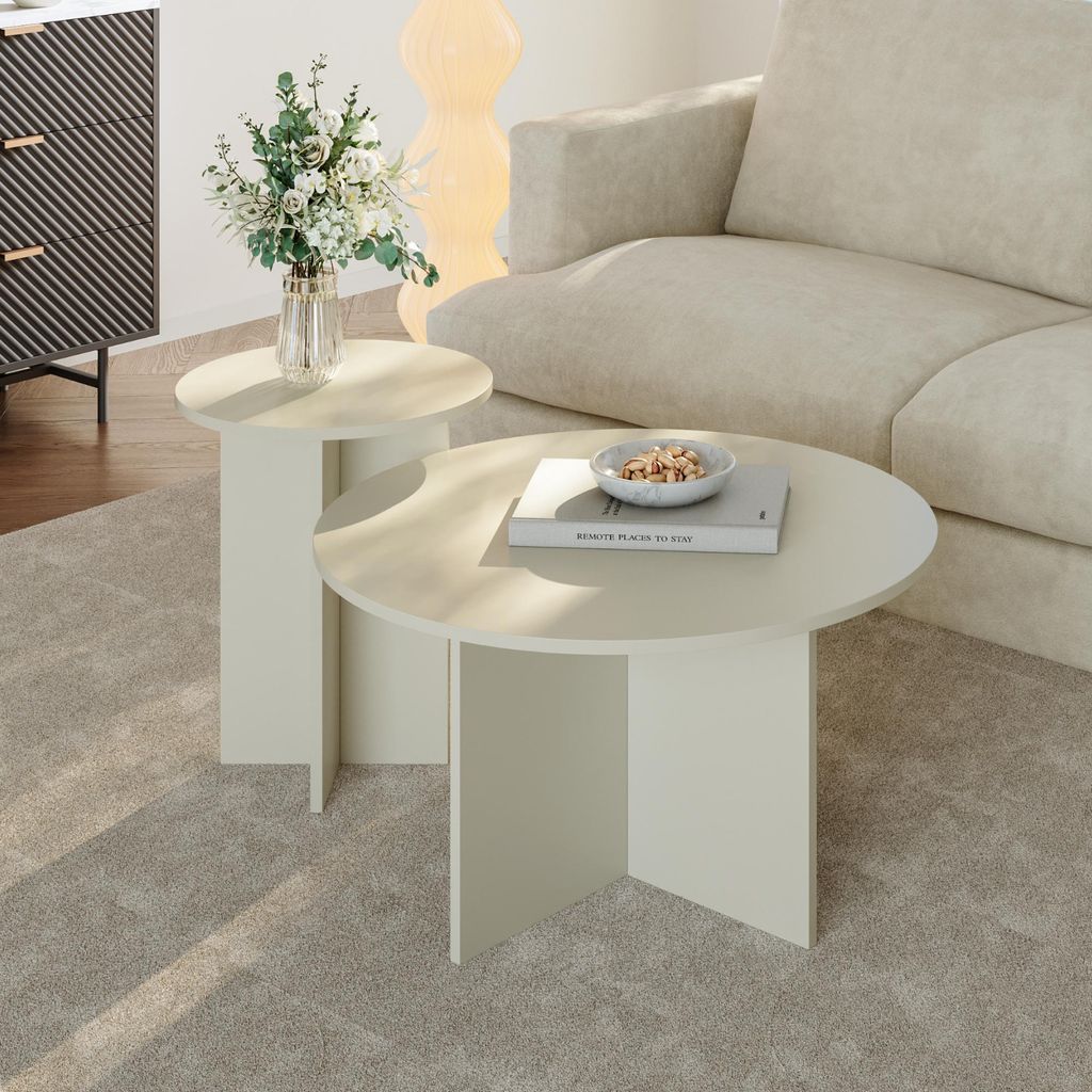 A living room scene with two round side tables, a sofa, and a cabinet.