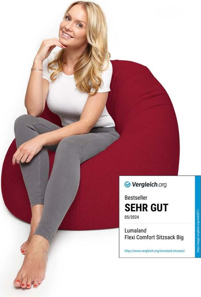 A woman is sitting on a red beanbag chair.