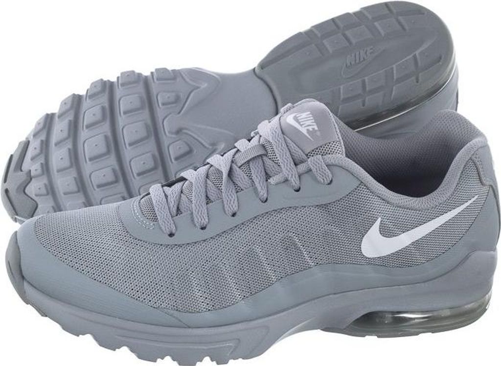 A pair of gray Nike Air Max Invigor shoes are shown against a white background.