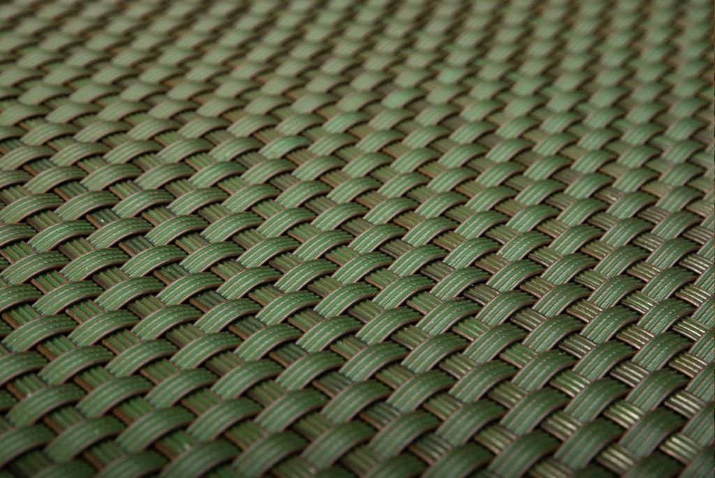 A close-up, angled view of a woven green material, likely a balcony screen or fence covering.