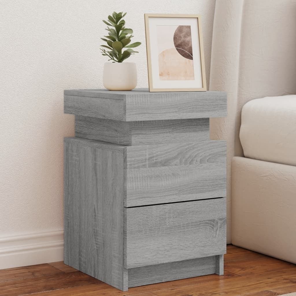 A bedside table with two drawers next to a bed.