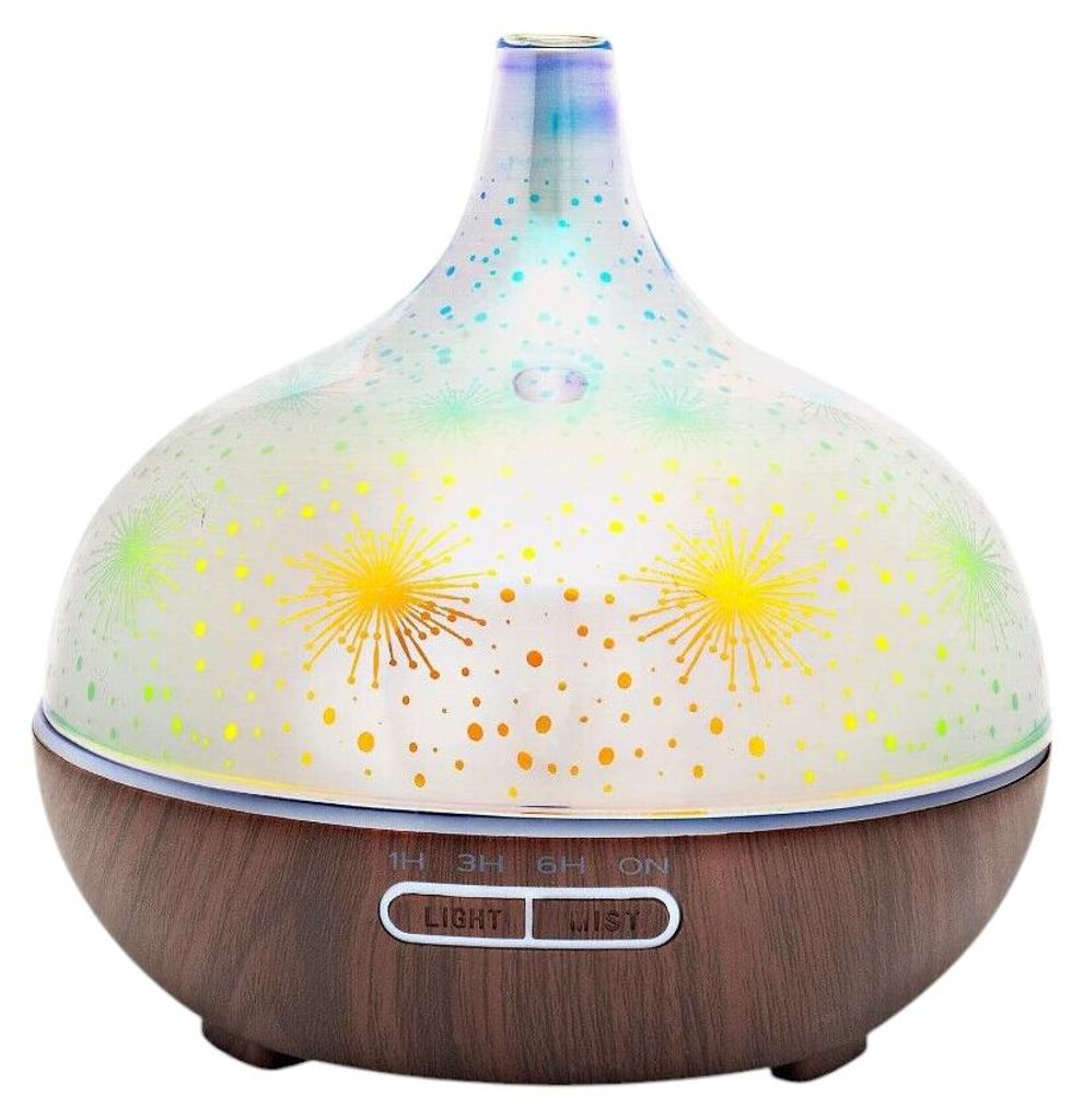 A close-up studio shot of an aroma diffuser with a wood-look base and a patterned glass dome.