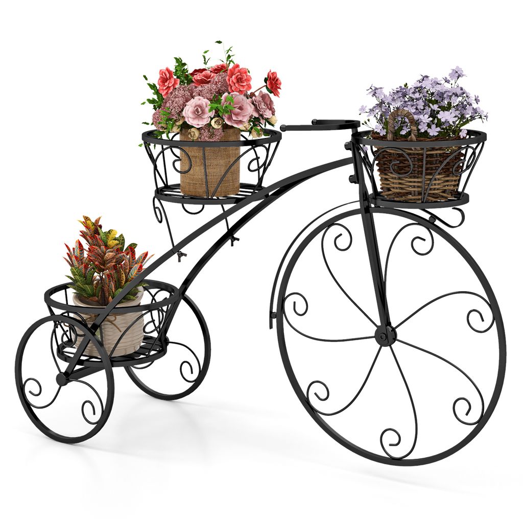 A black metal bicycle-shaped plant stand with three baskets holding potted plants.