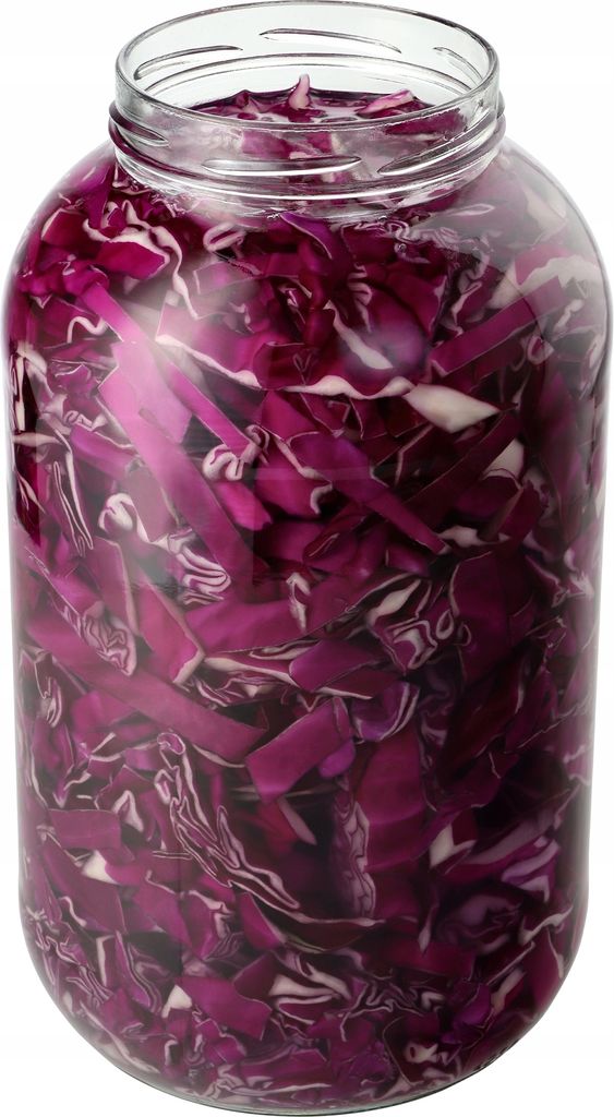 A clear, well-lit studio shot of a large glass jar filled with chopped red cabbage, likely for pickling or fermentation.