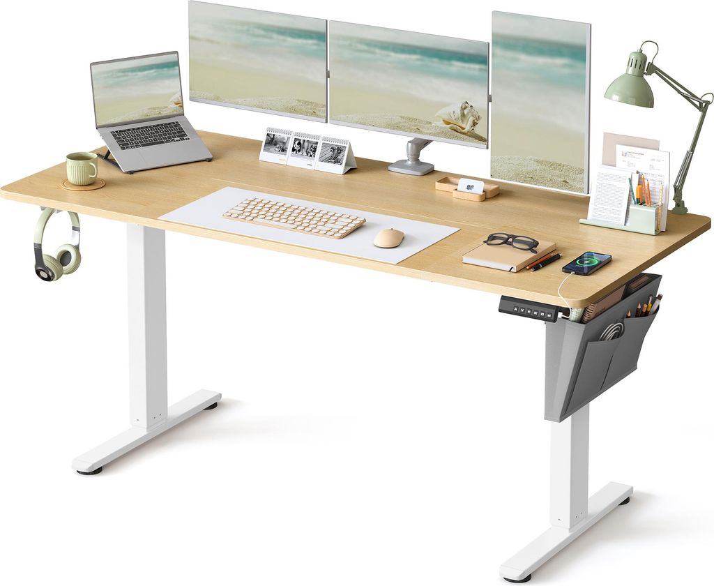 A modern adjustable height desk setup with multiple monitors, a laptop, and various desk accessories.