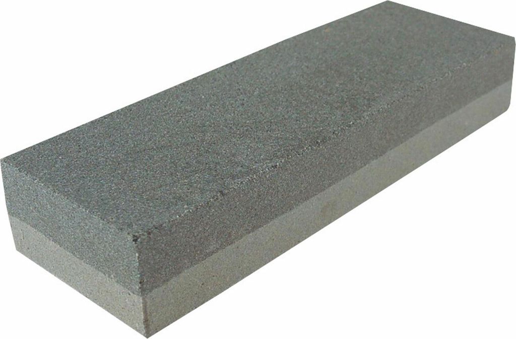 A sharpening stone with two different grit surfaces.