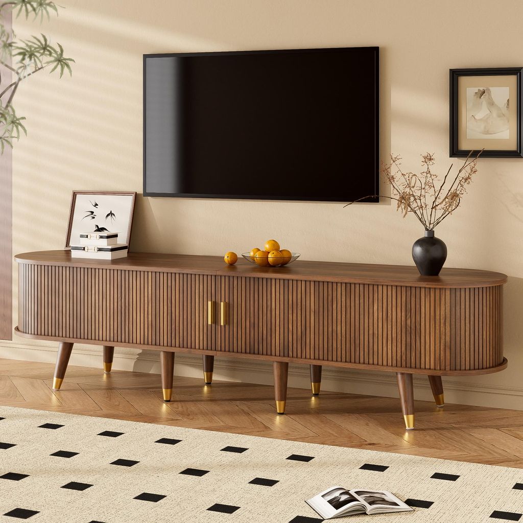 A living room scene featuring a TV stand with a television mounted above it.