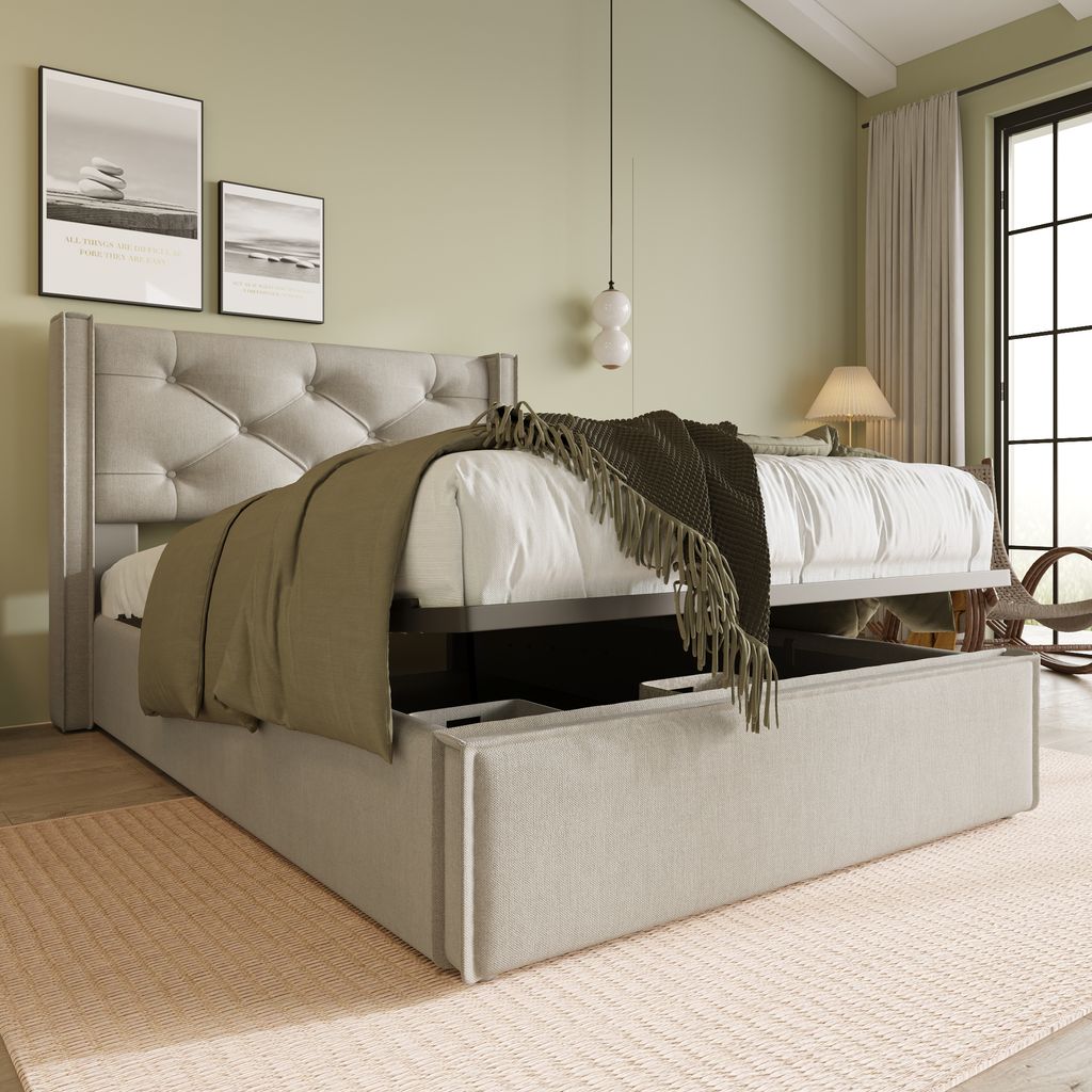 A bedroom scene with a bed featuring storage, artwork on the wall, and a window.
