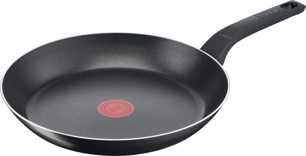 A black frying pan with a red heat indicator in the center and a black handle, isolated on a white background.