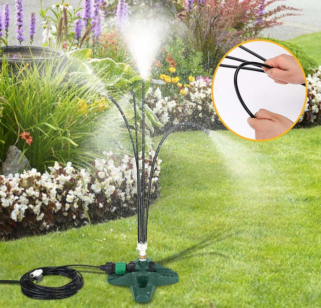 A garden sprinkler system with multiple spray nozzles is shown watering a lawn and flower bed.