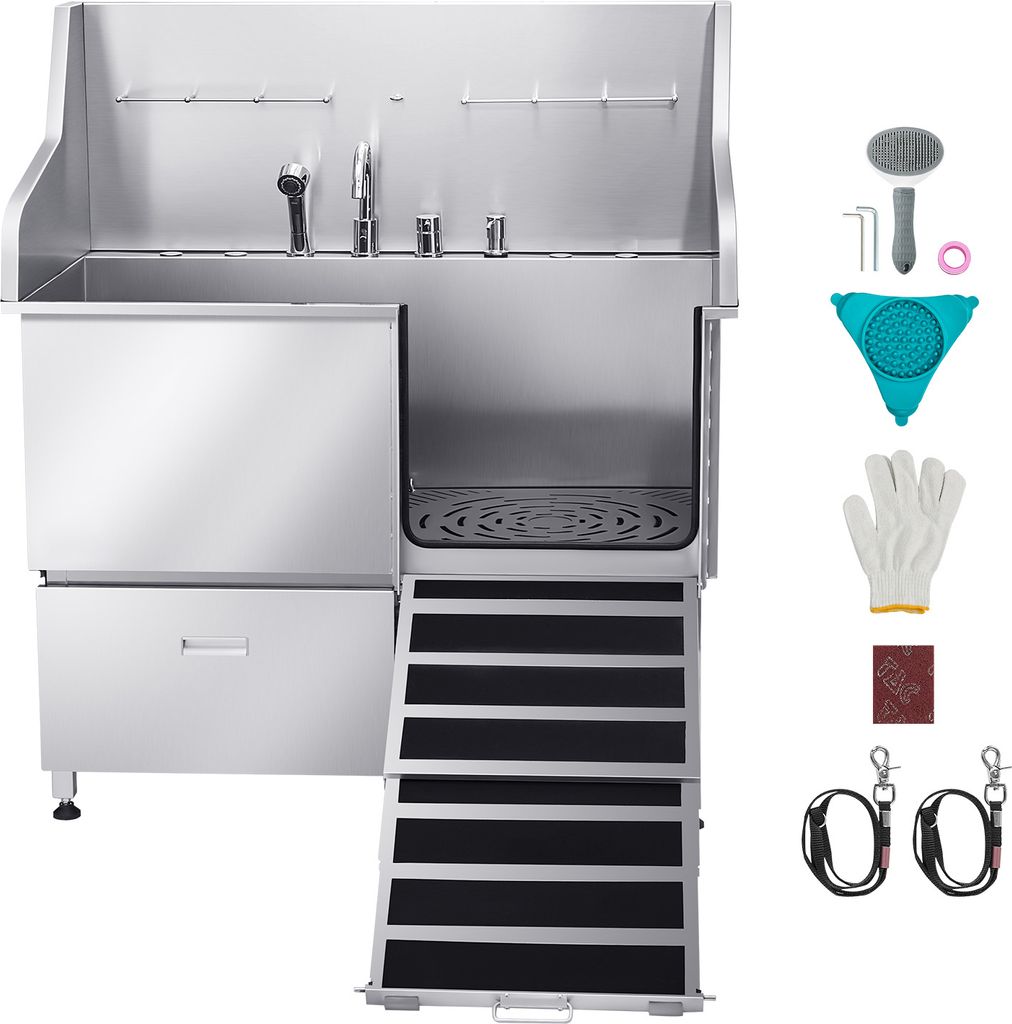 A stainless steel pet grooming tub with a ramp and various accessories displayed to the right.