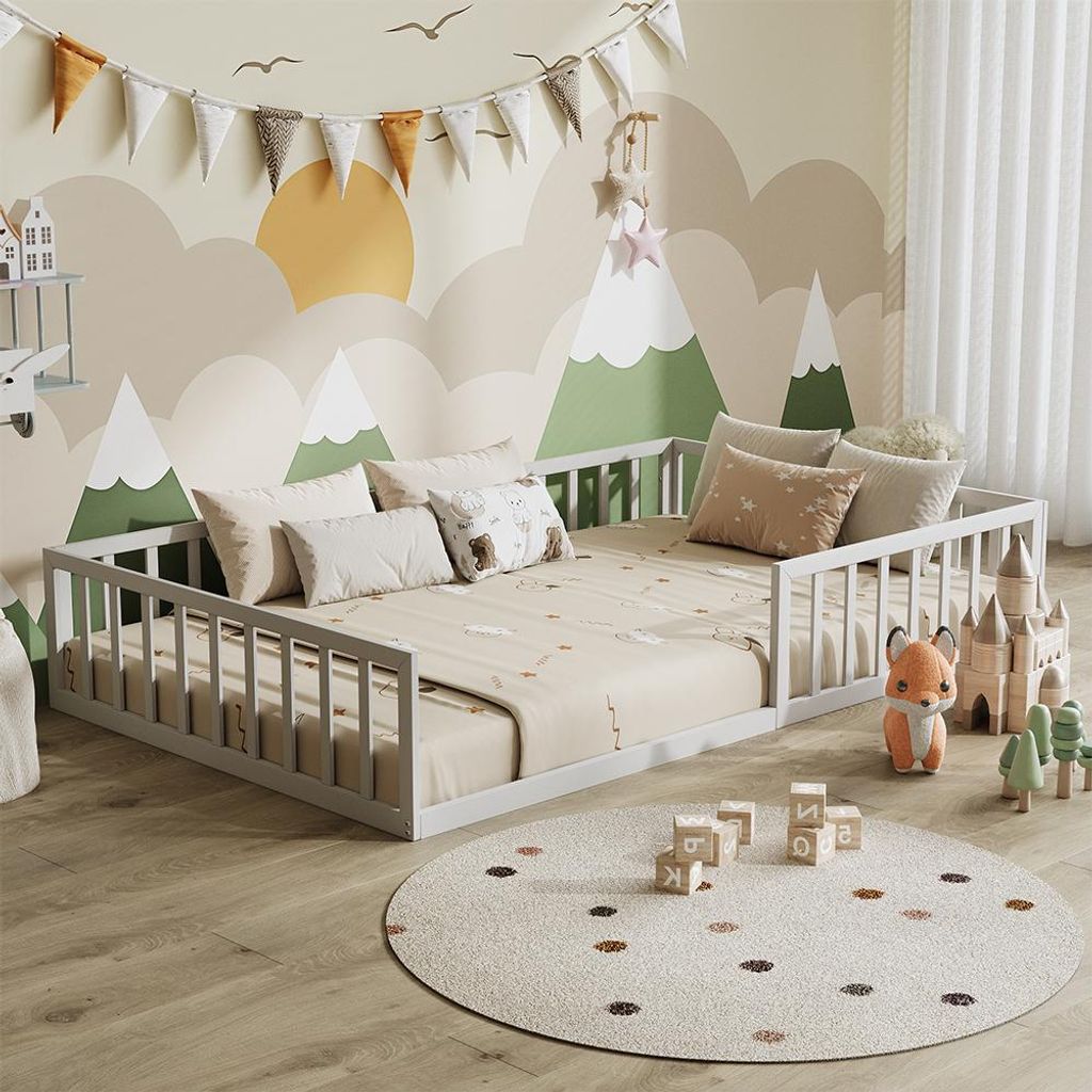 A child's bedroom with a low bed, toys, and a mountain-themed mural.