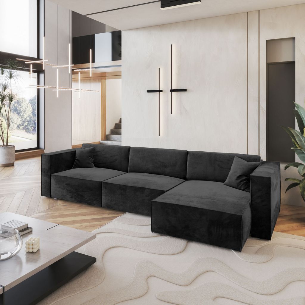 A modern living room with a large sectional sofa, coffee table, and abstract wall art.