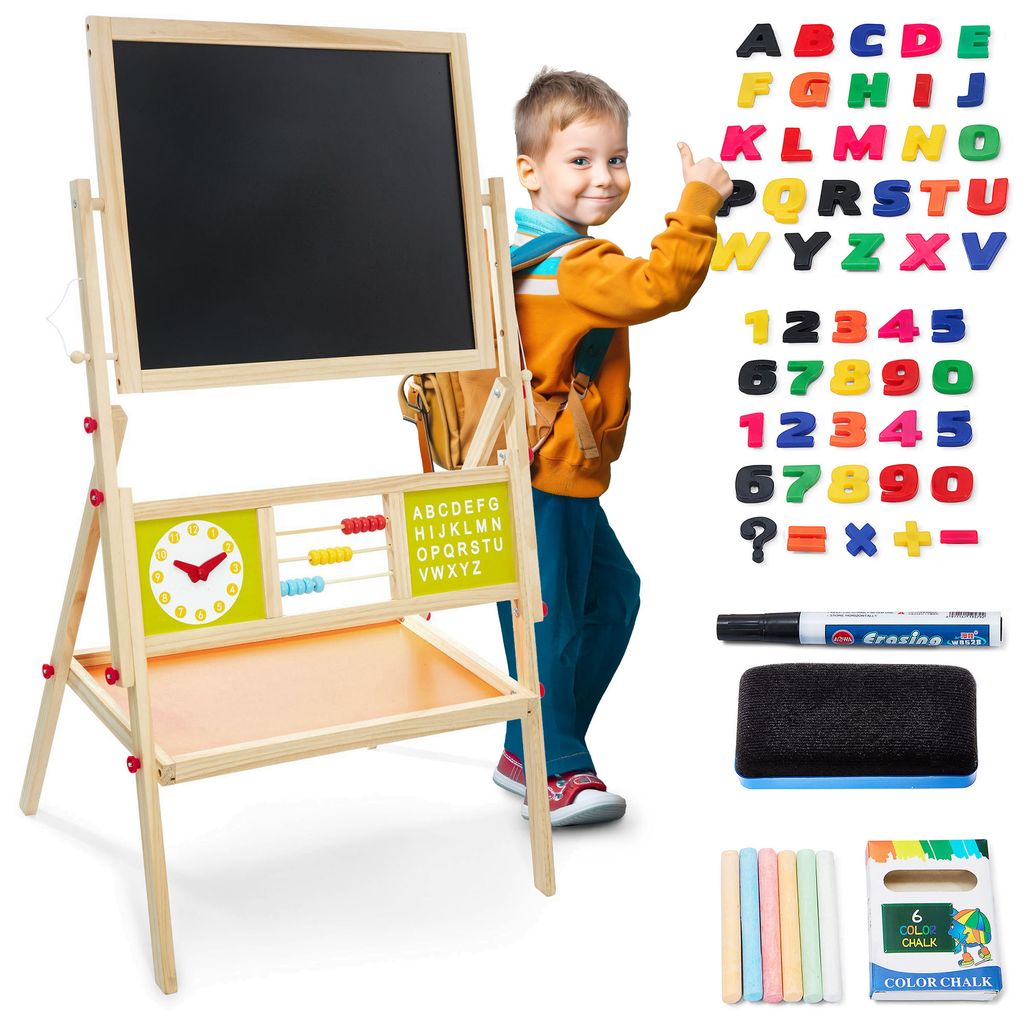 A young boy is giving a thumbs up next to a wooden easel with a blackboard, whiteboard, and educational accessories.