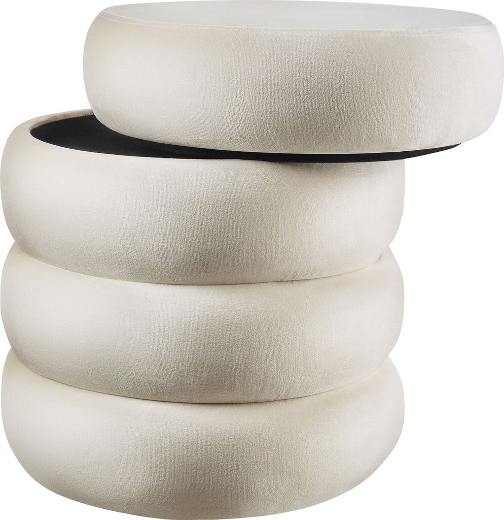 Four cream-colored, round ottomans are stacked on top of each other.
