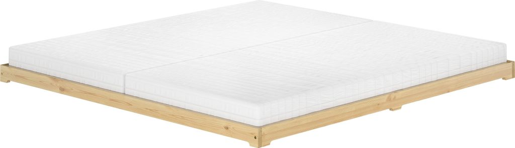 A low-profile wooden bed frame with two mattresses on a white background.