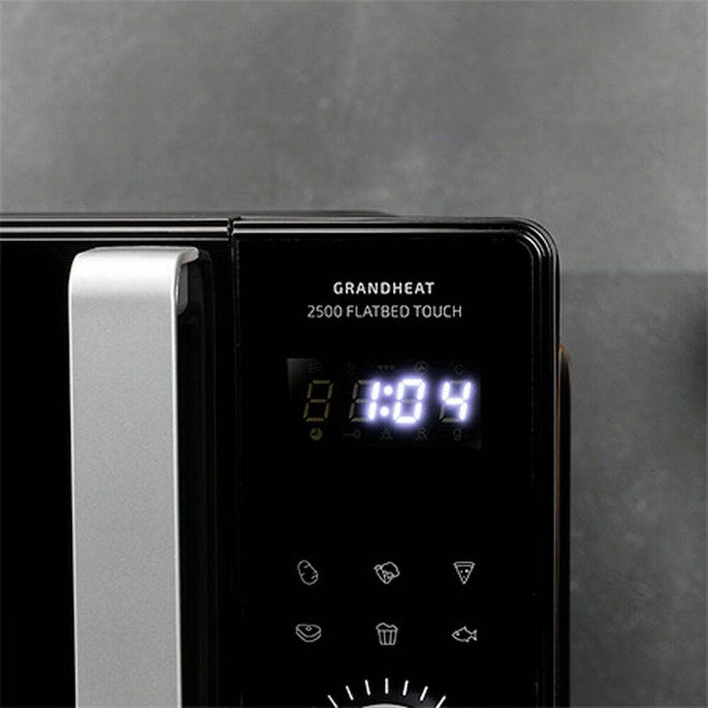 A close-up view of the digital display and control panel of a black microwave oven.