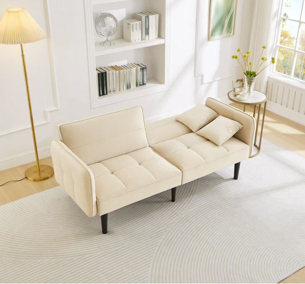 A beige sofa bed is shown in a living room setting.