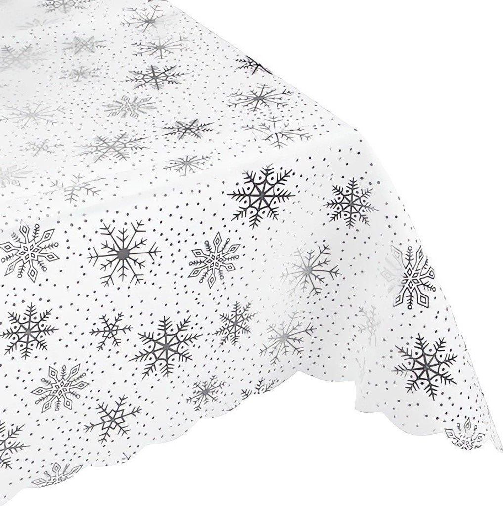 A close-up, angled view of a white tablecloth with a silver snowflake pattern.
