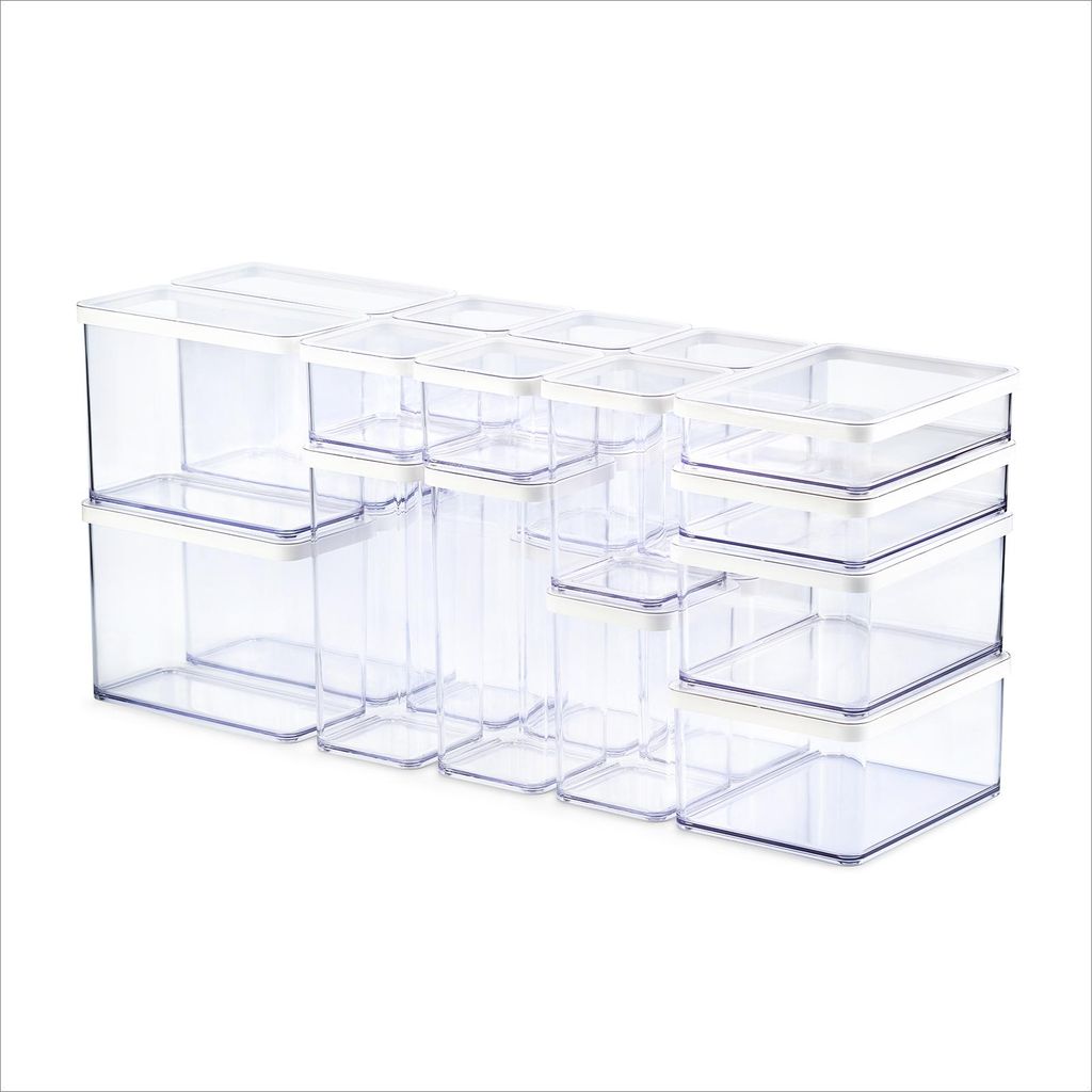 A set of clear plastic food storage containers with white lids, arranged in a row on a white background.