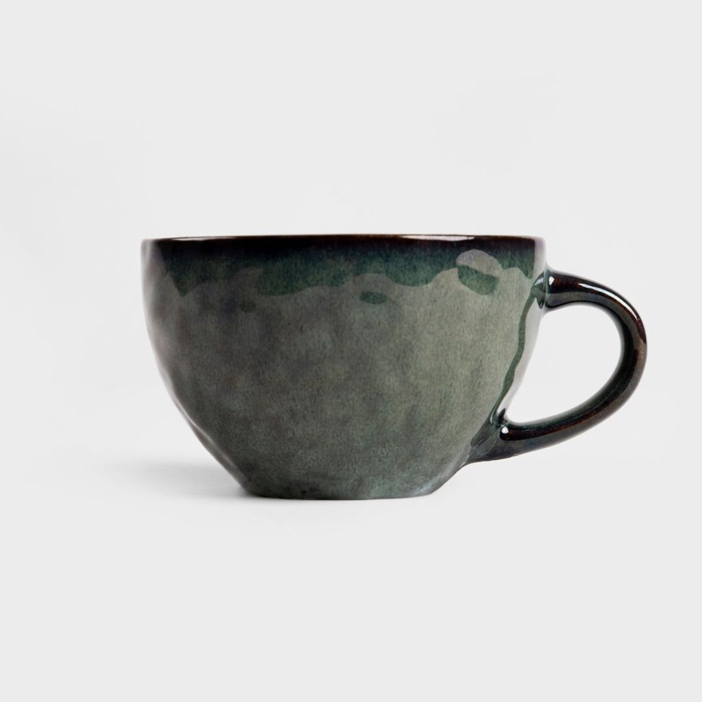 A dark green ceramic mug is shown against a white background.