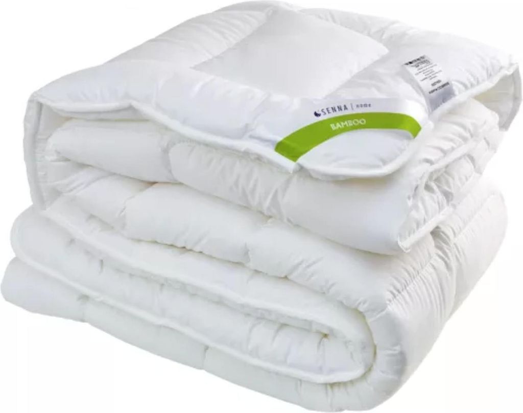 A folded white comforter is shown against a white background.