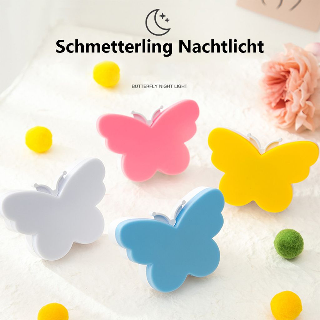 A collection of butterfly-shaped night lights arranged on a white surface with small pom-poms.