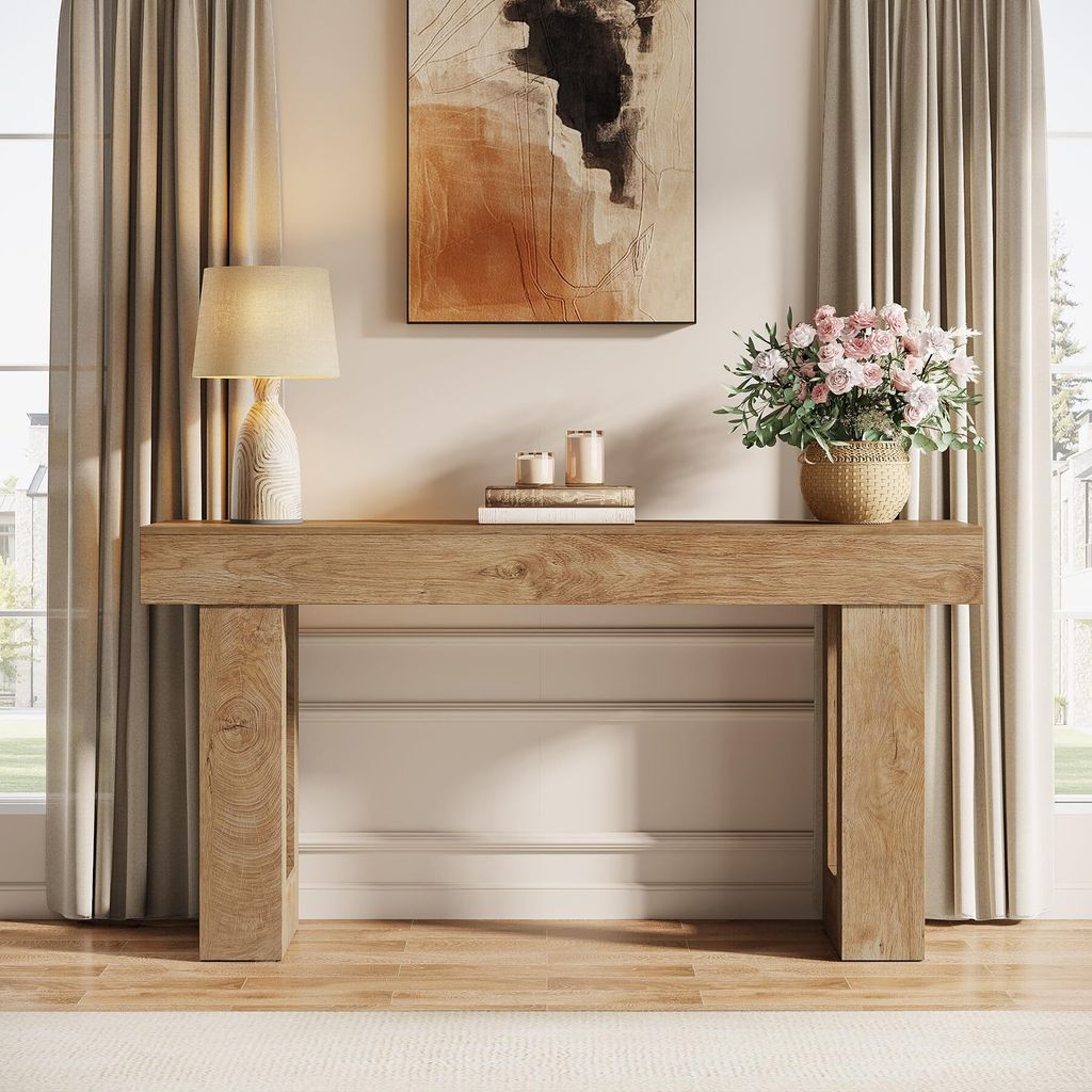 A wooden console table with decorative items in a living room setting.