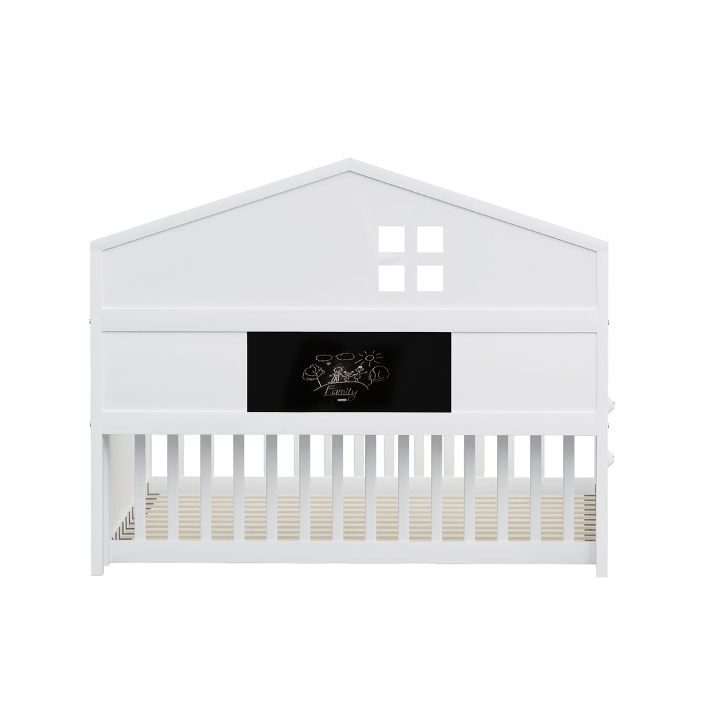 A white crib with a house-shaped headboard and a chalkboard panel.