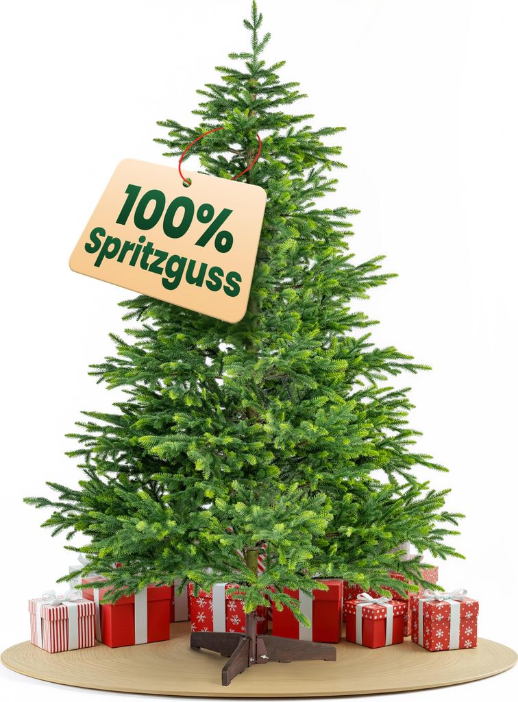 A green artificial Christmas tree with presents underneath and a tag indicating "100% Spritzguss".