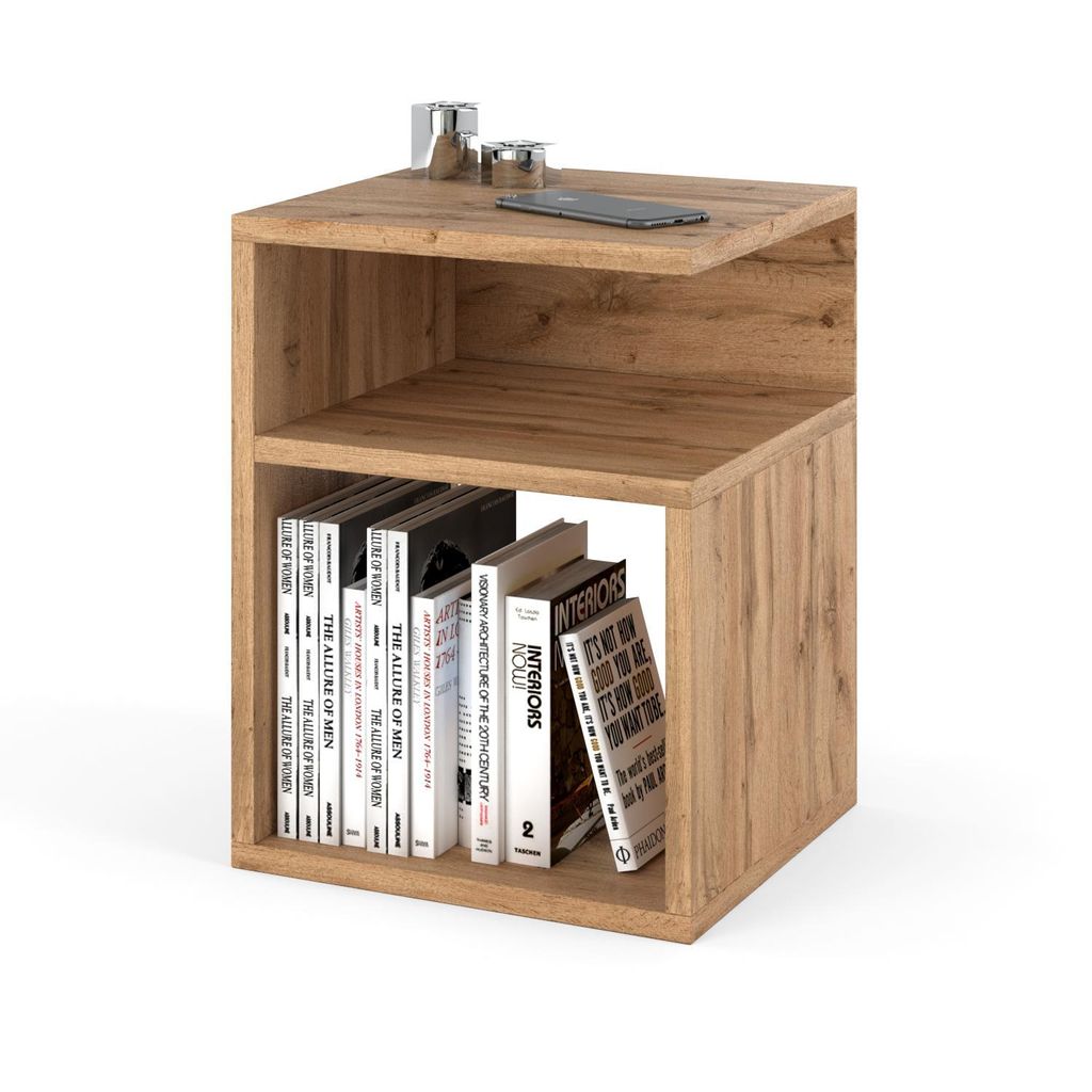 A wooden side table with books on the bottom shelf and a phone and decorative items on the top shelf.