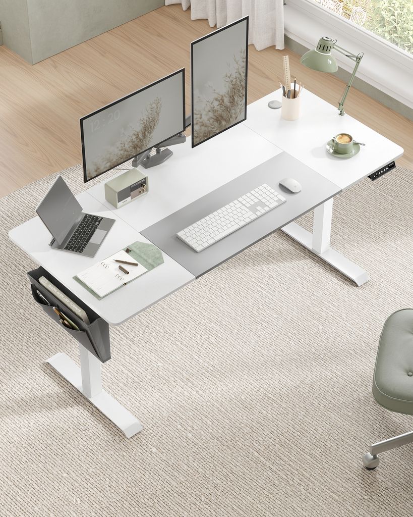 A modern standing desk setup with dual monitors, a laptop, keyboard, mouse, and desk accessories.