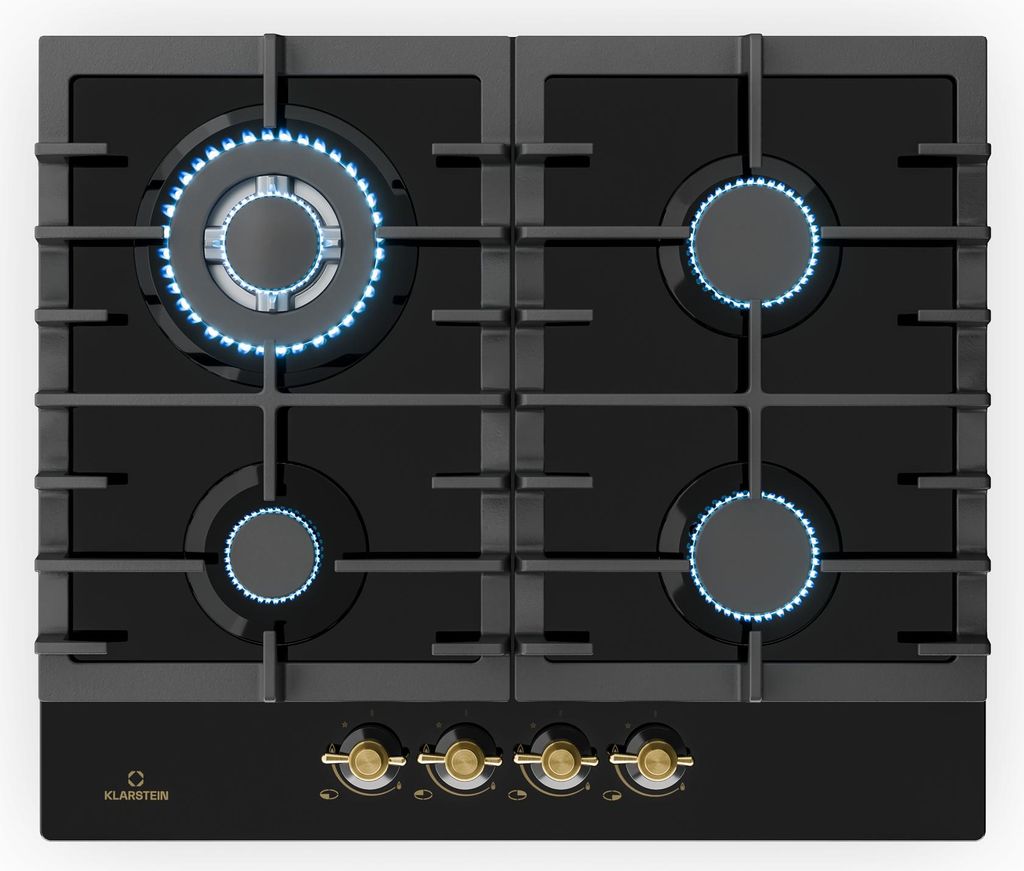 A top-down view of a black gas stovetop with four burners, two of which are lit with blue flames. The stovetop has a black glass surface and a black control panel with four gold knobs.