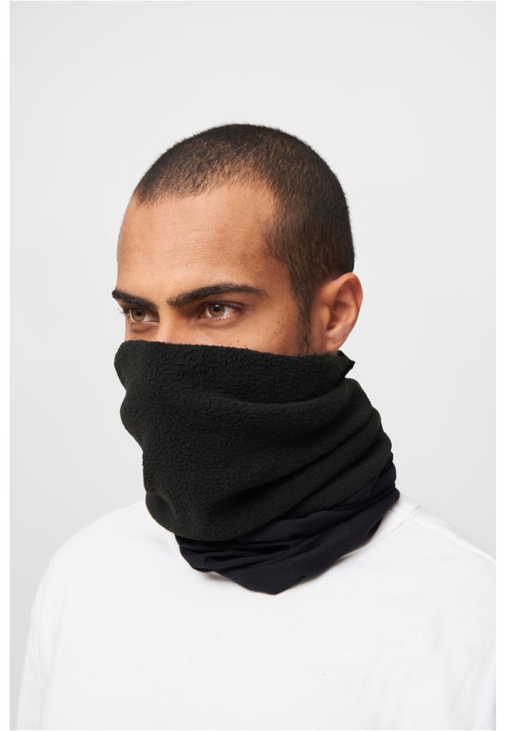A man wearing a black neck gaiter and a white t-shirt against a white background.